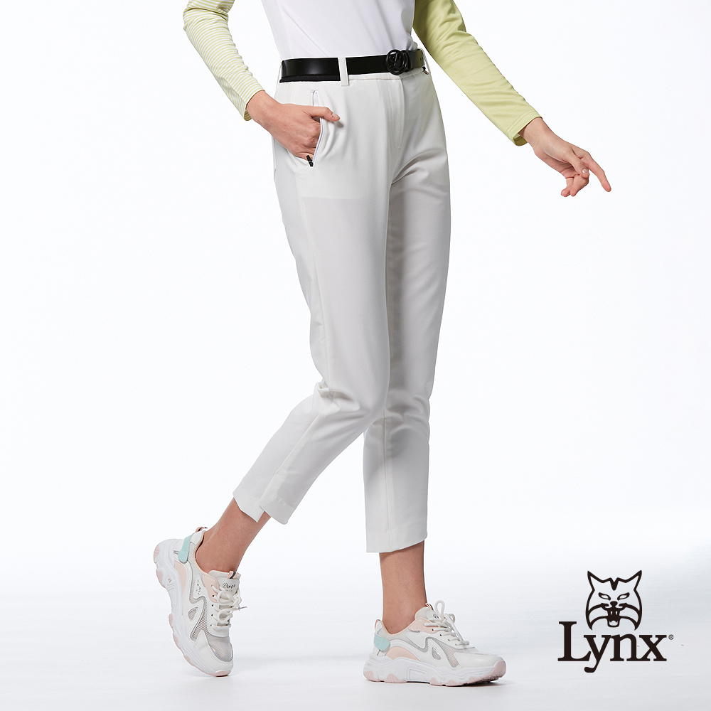 Lynx Golf 女款日本進口布料彈性舒適西褲造型開杈設計拉鍊口袋窄管八分褲-白色